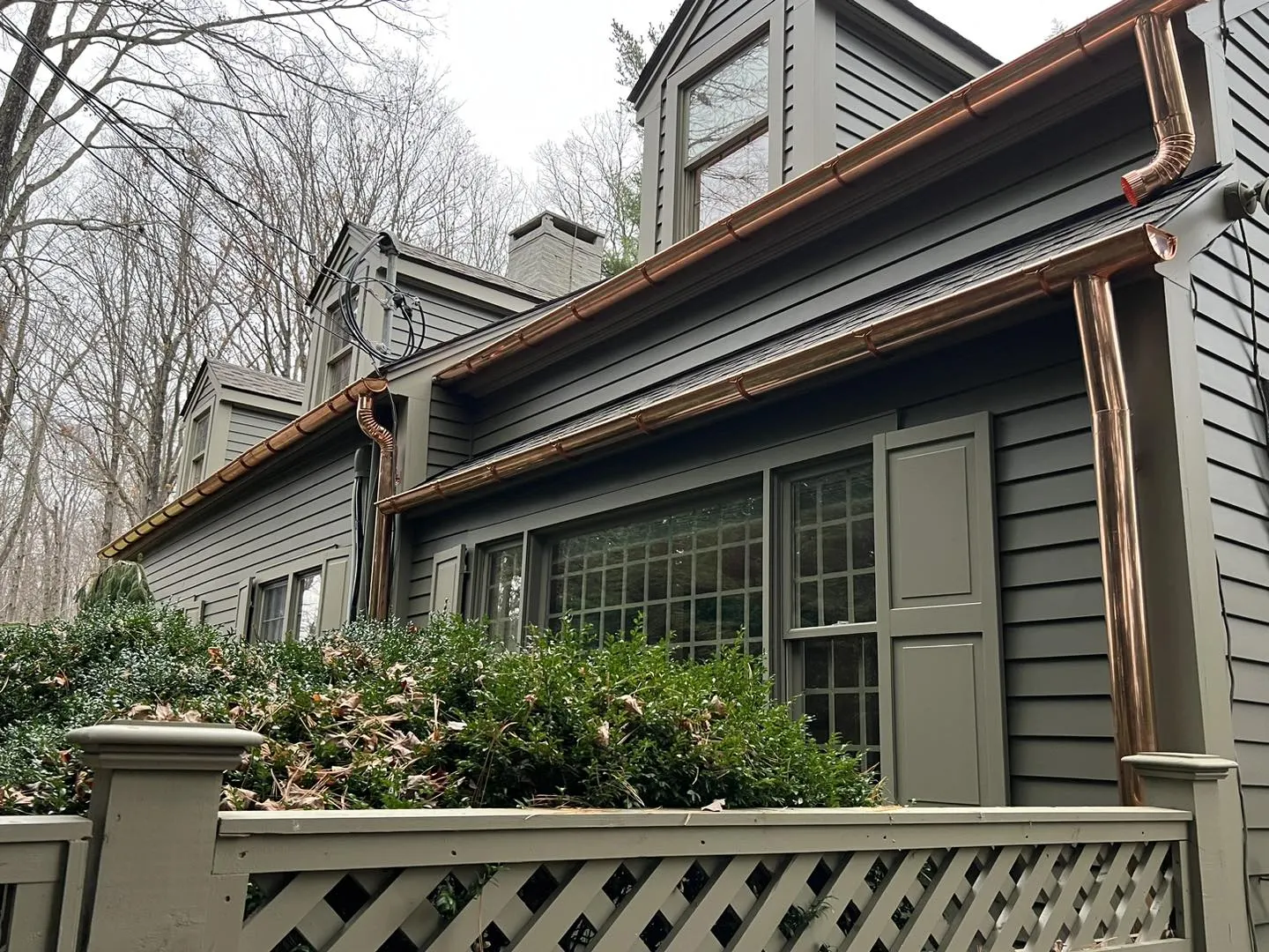 New copper gutter and downspout on a gray-sided home in Western CT