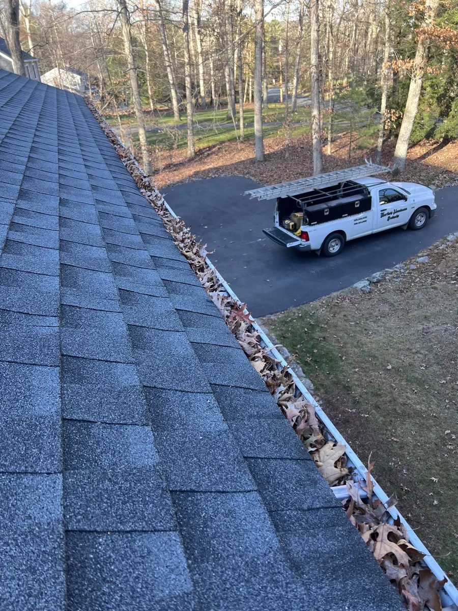 Before - gutter packed with fallen leaves on a Southbury, CT home