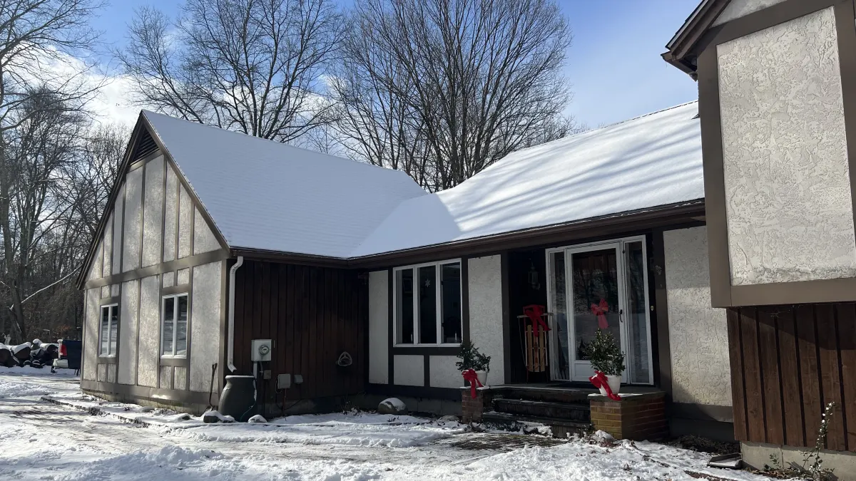 Before - stucco and timber front entry and low wing on a Southbury, CT Tudor home