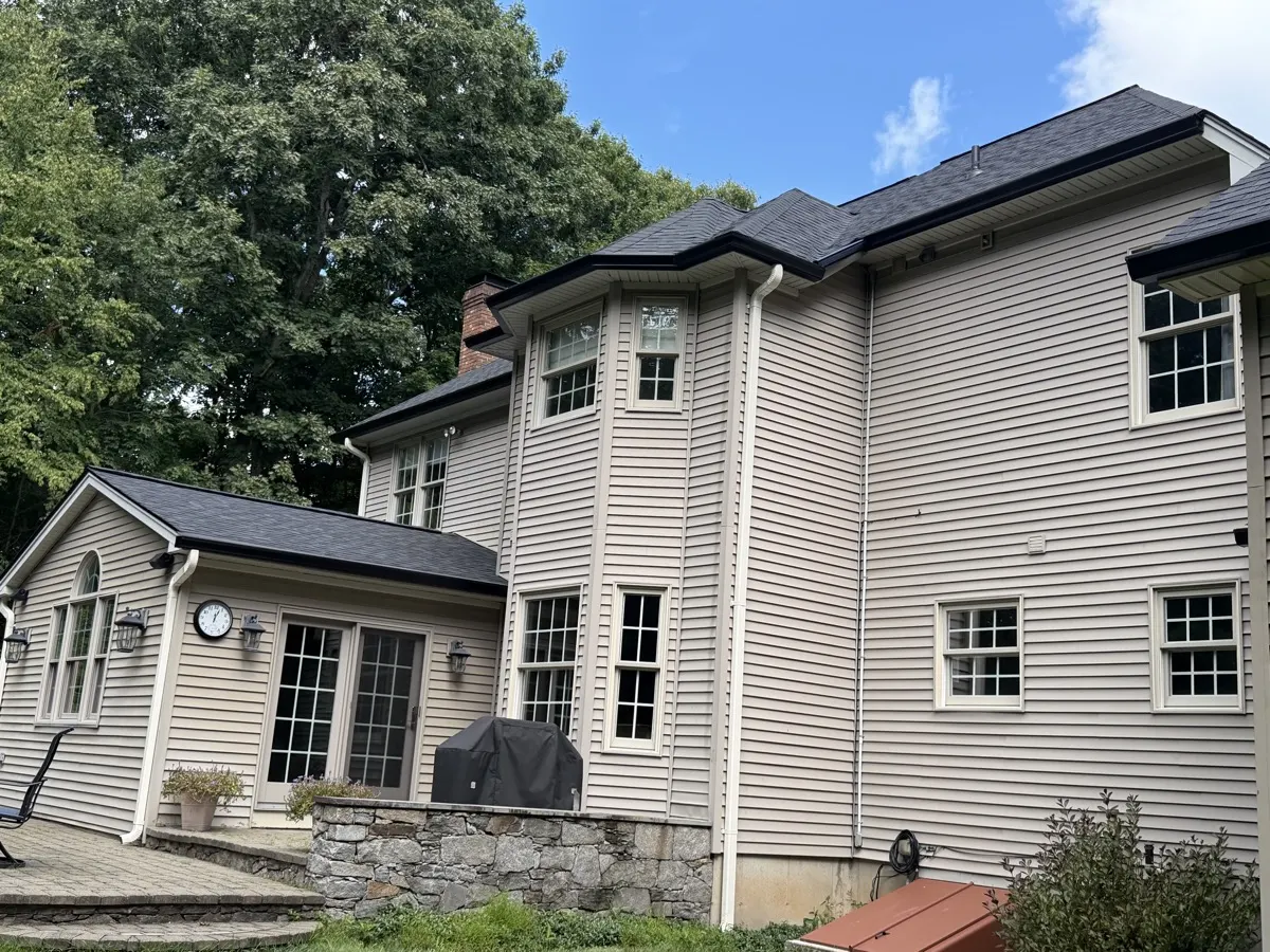 New seamless aluminum gutters and downspout along the rear eaves of a Southbury, CT home by Martin's Aluminum