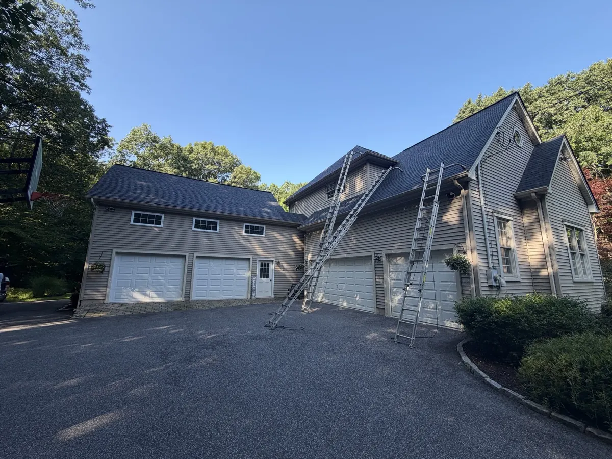 Ladders set for a seamless gutter installation on a Southbury, CT home by Martin's Aluminum