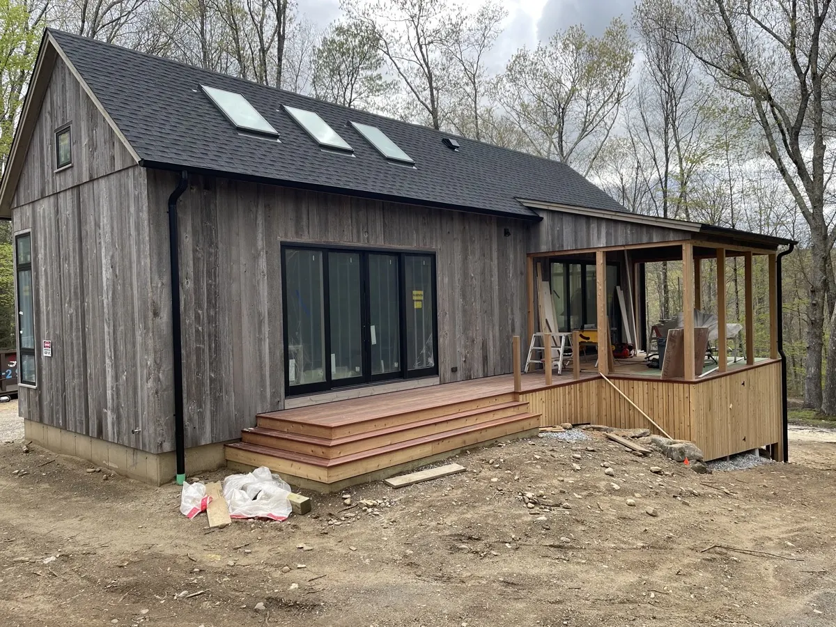 Black seamless gutters and downspout on a modern barn-style home in Southbury, CT by Martin's Aluminum